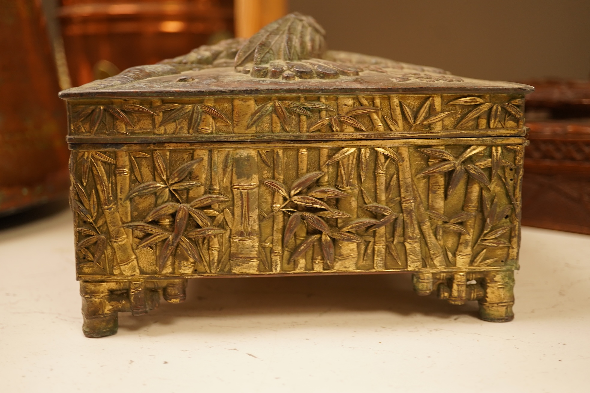 A late 19th century Japanese gilt metal lidded box together with a Burmese carved hardwood box, 28cm wide
